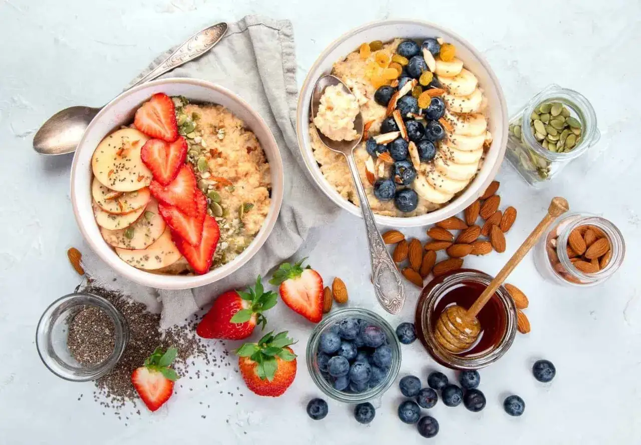 Dos tazones de avena con frutas, frutos secos y miel. &iexcl;Cuidado! la avena engorda si no se consume con moderaci&oacute;n.